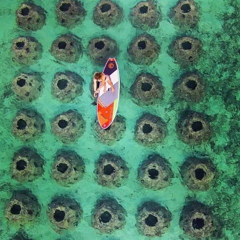 SurfboardoverSubmergedReefBallBreakwater SurfboardoverSubmergedReefBallBreakwater