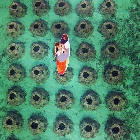 SurfboardoverSubmergedReefBallBreakwater