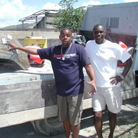 Naseem and michael placing Moulds on the truck to be shipped 